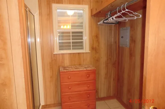 Cabin closet with dresser and hangers